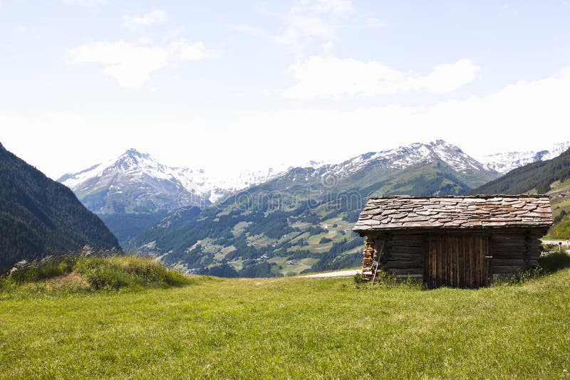 Small shed in National Park Hohe Tauern in Carinthia against the background of the Glockner mountains, the highest mountains of Austria. Small shed in National Park Hohe Tauern in Carinthia against the background of the Glockner mountains, the highest mountains of Austria.