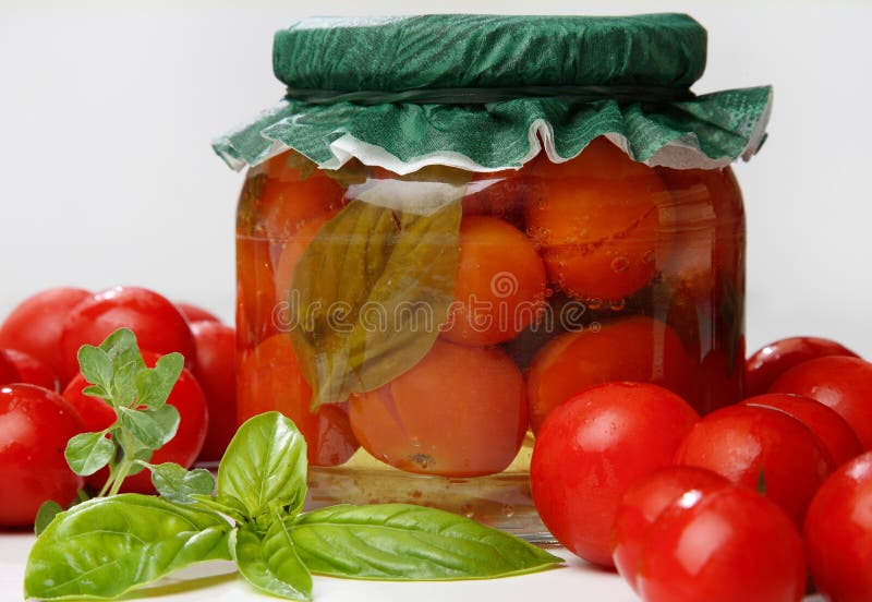 Pickeled green and red tomato in jar
