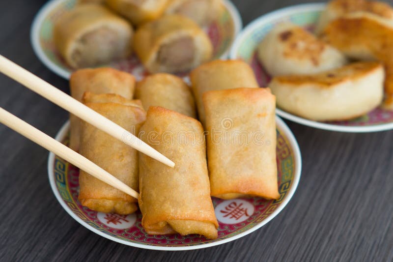 Picking up Spring Rolls with chopsticks royalty free stock images Picking up Spring Rolls with chopsticks royalty free stock images