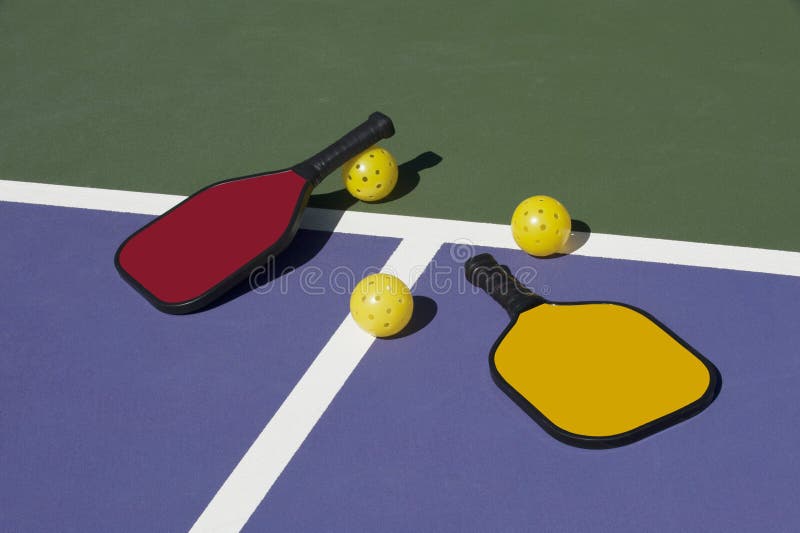 Pickleball - colorful paddles, ball and court