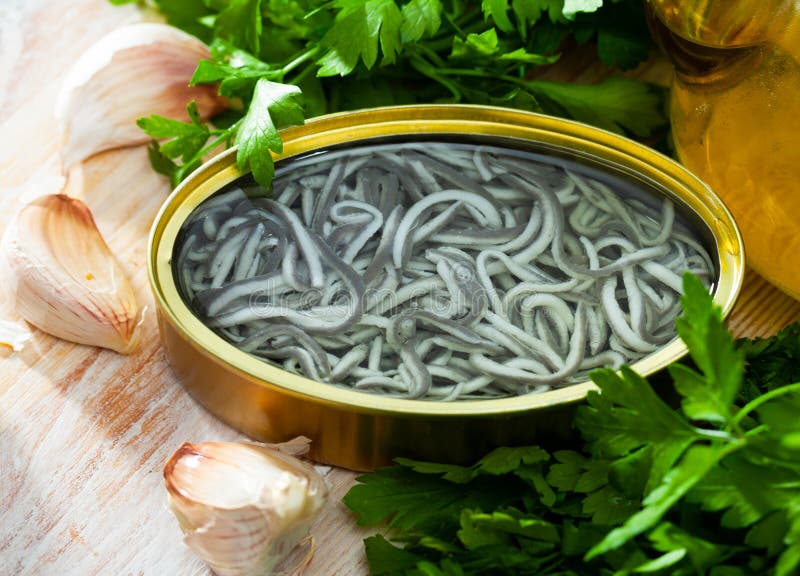 Pickled Eels in Open Tin Can with Garlic at Table Stock Photo Image of delicious, greens