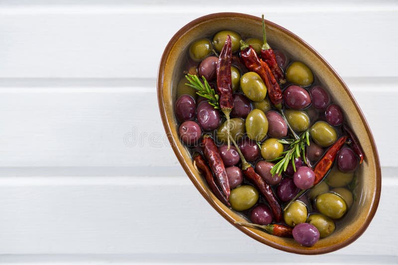 Pickled Olives with Herbs and Chili in Bowl on Table Stock Image