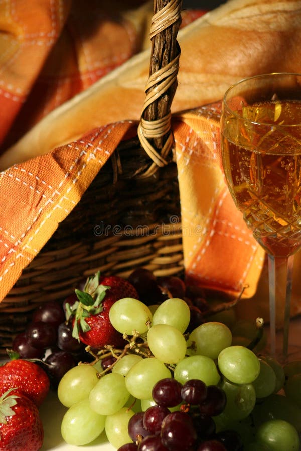 Picnic basket with wine, fruit and bread
