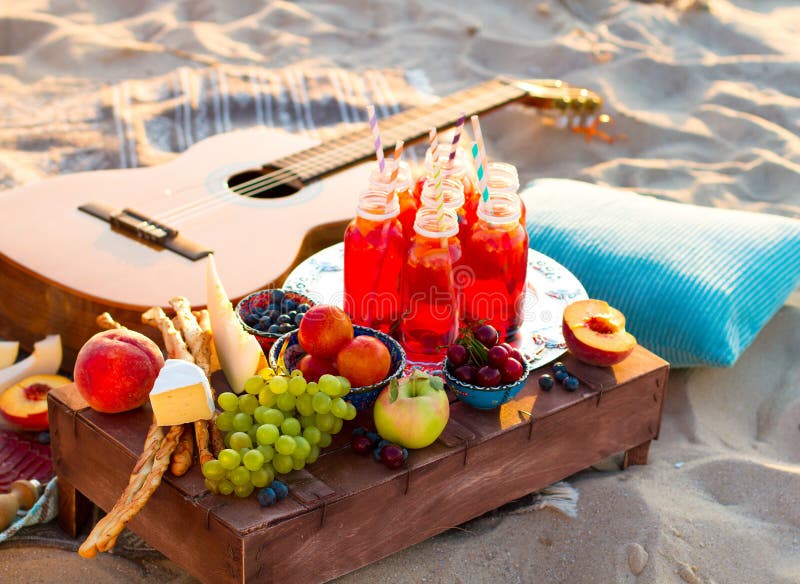 Picnic on the beach at sunset in the boho style