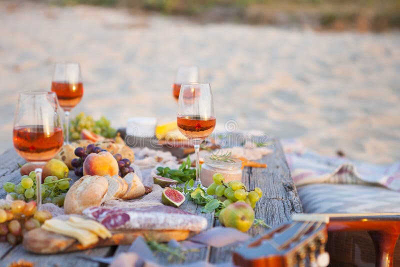 Picnic on the Beach at Sunset in Boho Style, Food and Drink Conc Stock