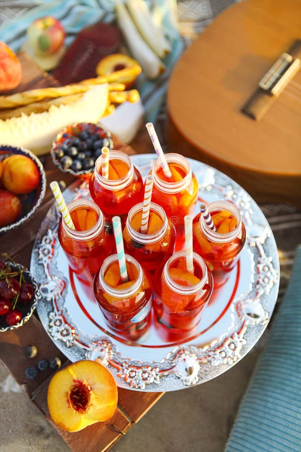 Picnic on the beach at sunset in the style of boho