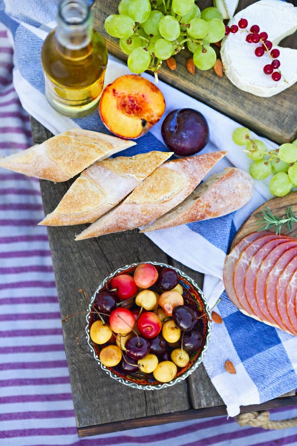 Picnic on the beach at sunset in the style of boho