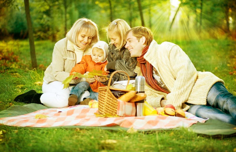 Picnic in Autumn park.Happy Family outdoors. Picnic in Autumn park.Happy Family outdoors