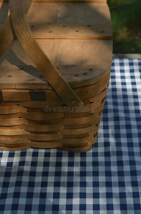Picnic Table with Vintage Picnic Basket, Blue Checked Table Cloth Stock