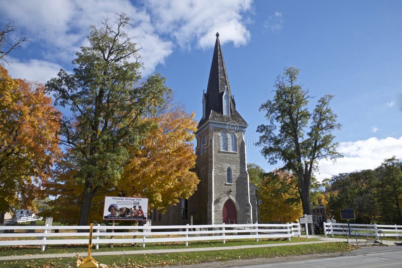 Historic Heritage Catholic Church building exterior with autumn leaf colour