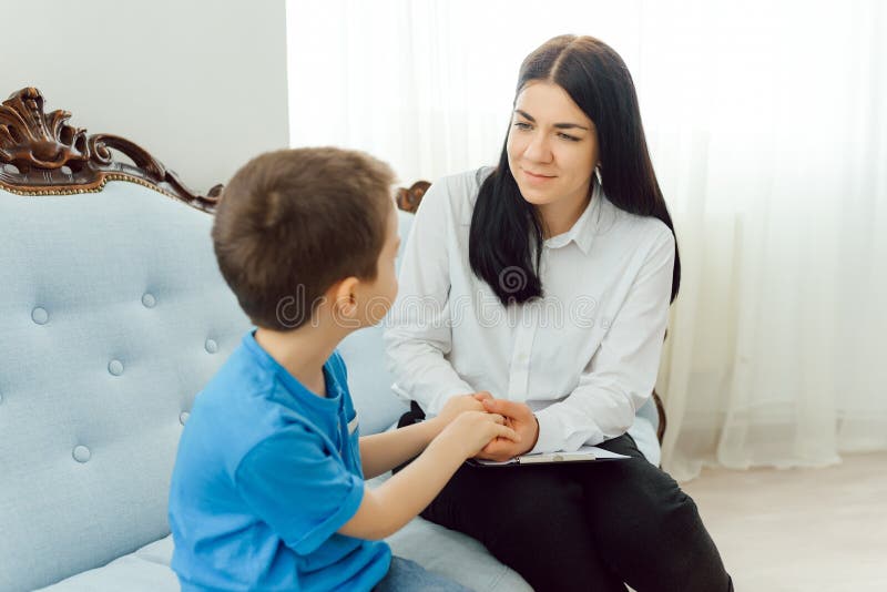 Picture of Child Psychologist Working with Young Boy in Office Stock