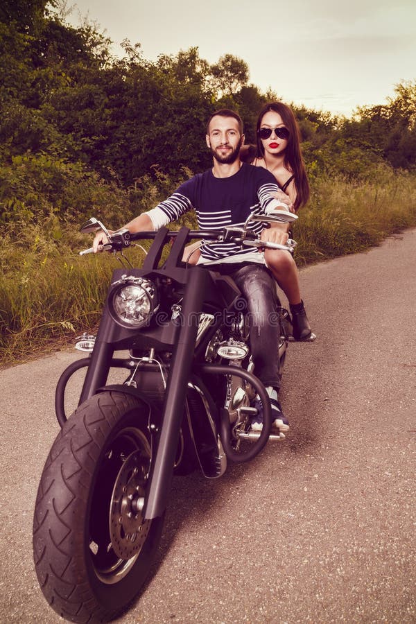 Picture with a couple of beautiful young bikers royalty free stock image Picture with a couple of beautiful young bikers royalty free stock image