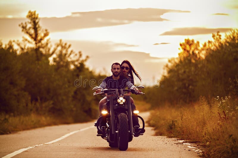 Picture with a couple of beautiful young bikers royalty free stock photo Picture with a couple of beautiful young bikers royalty free stock photo