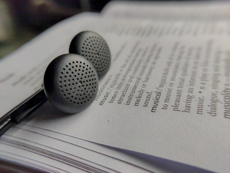 Picture of Earphones on a Dictionary Book. Stock Photo Image of