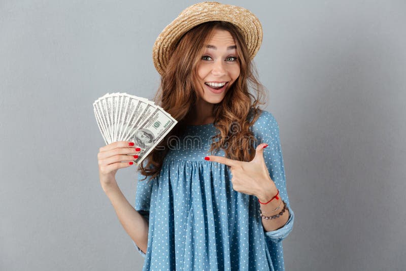 Excited young cheerful woman holding money.