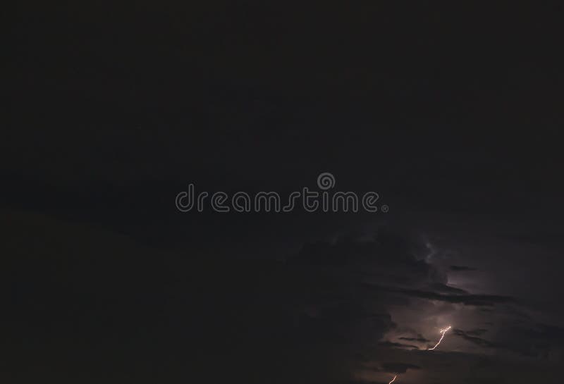 Picture of a Flash in the Night Sky with Glowing Clouds Stock Image