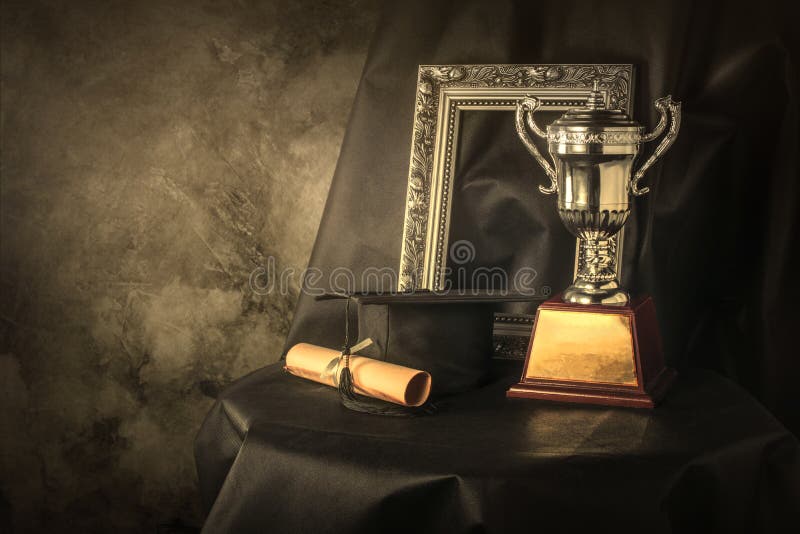 picture frame, trophy cup and graduates still life photography s