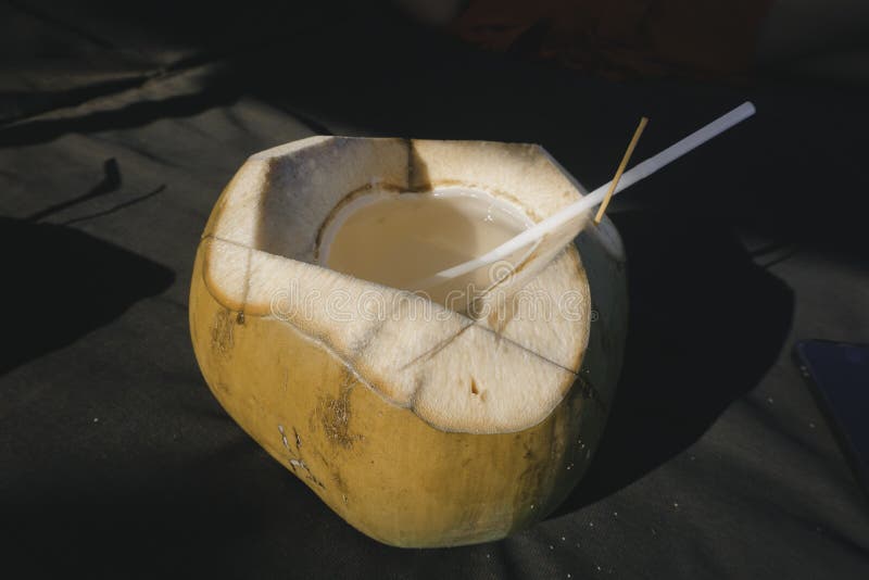 Picture of Fresh Coconut Juice on a Tropical Beach Stock Photo Image
