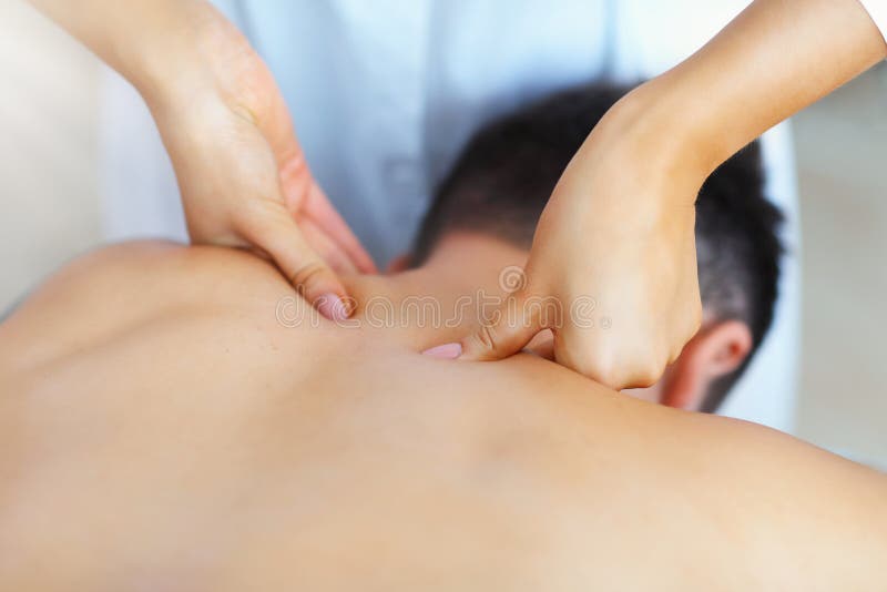 Handsome man having massage in spa salon stock photo Handsome man having massage in spa salon stock photo