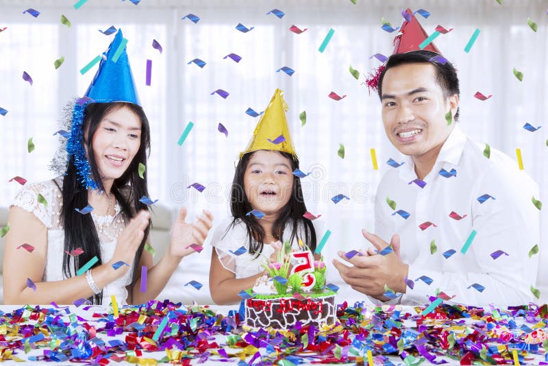 Happy parents celebrate birthday of their daughter stock photos Happy parents celebrate birthday of their daughter stock photos