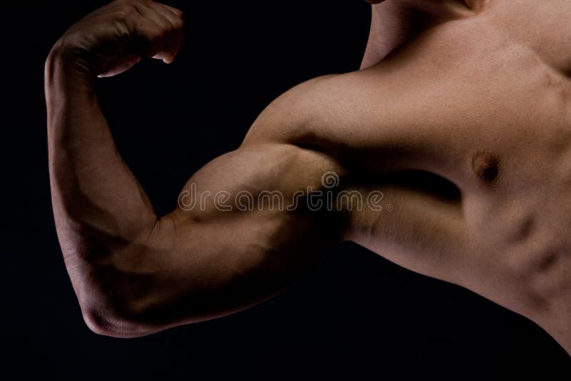 Picture of a muscular arm flexing on black background