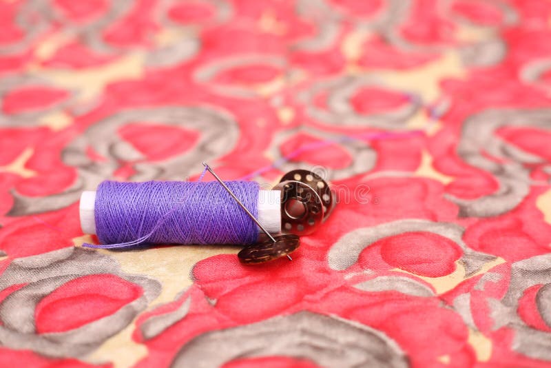 Picture of Purple Sewing Thread, Needle and Four Button Stock Photo