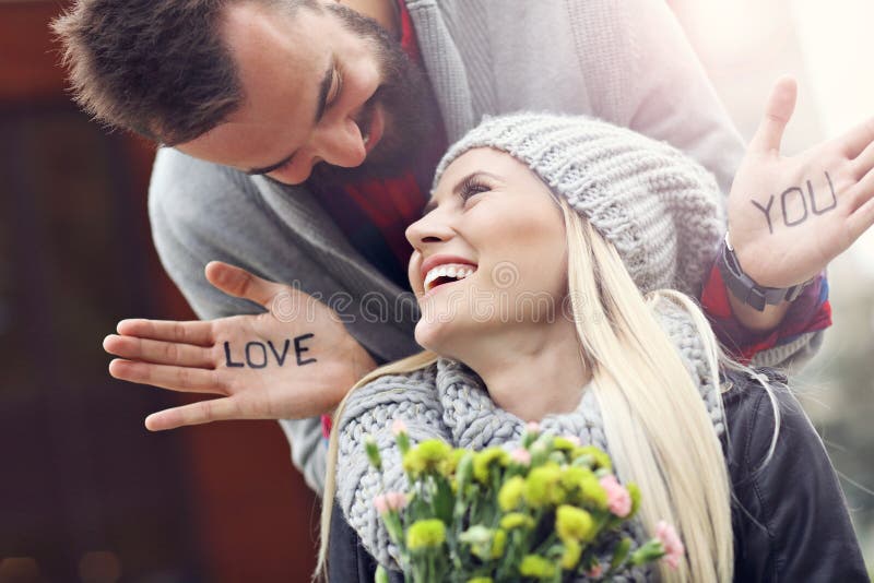 Happy couple with flowers dating in the city. Happy couple with flowers dating in the city