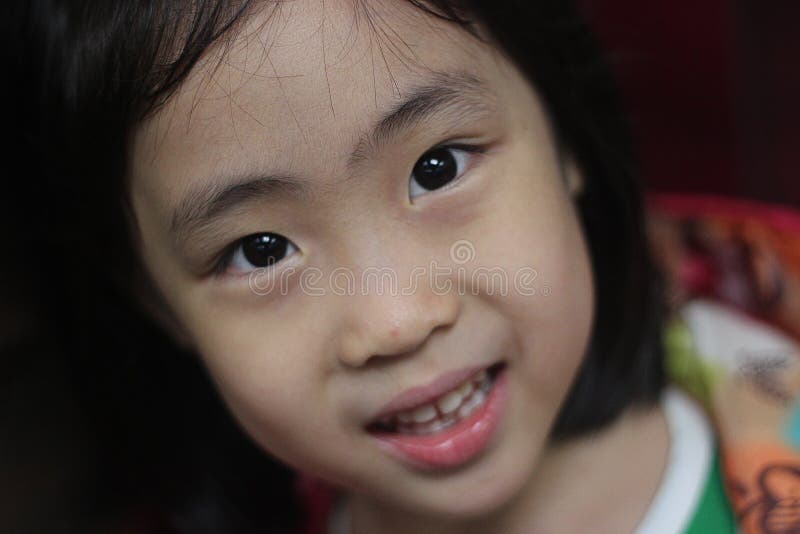 A Lovely Baby Girl is Raising Her Hand on Her Face with a Vietnamese ...