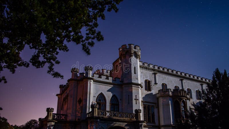 Night shot of neo gothic castle, clear sky with stars