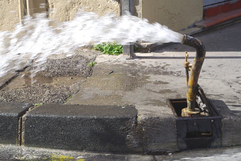 Picture of a water pipe flushing operation on the street. royalty free stock photos