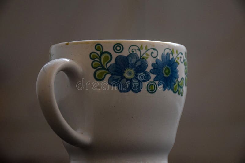 Picture of White Color Tea Cup with Blue Color Flower Design Stock
