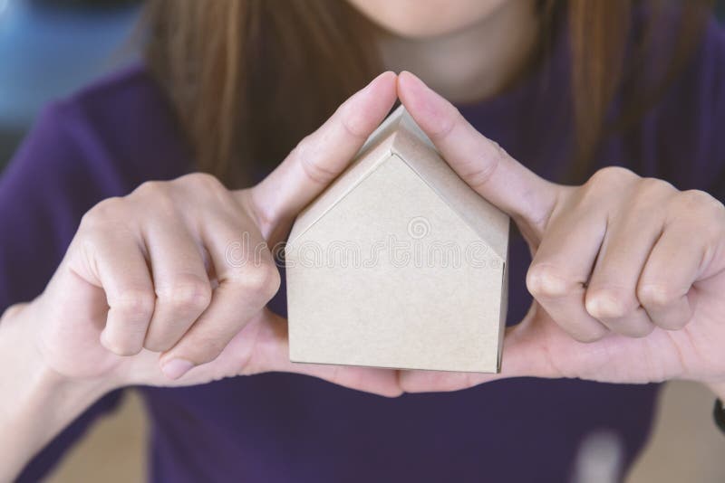 Picture of woman holding paper house model in her hands stock photos Picture of woman holding paper house model in her hands stock photos