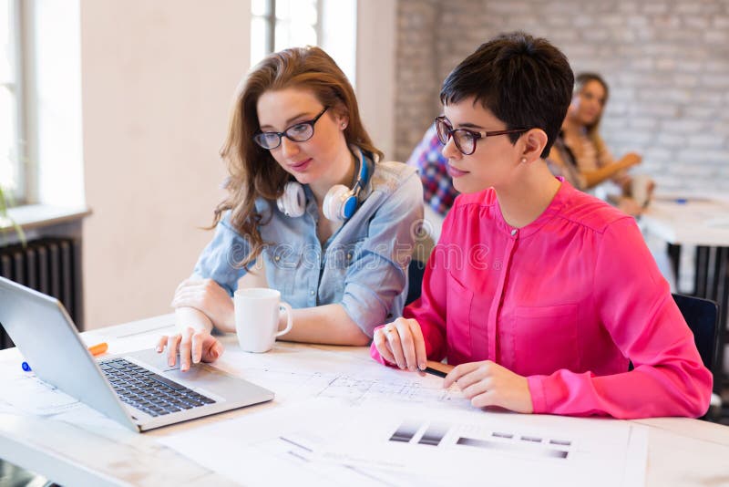 Picture of Young Architects Discussing in Office Stock Image - Image of ...