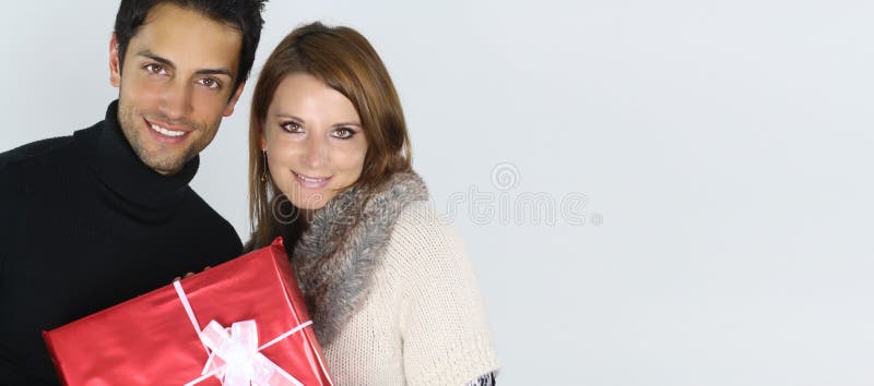 A picture of a young couple with a present royalty free stock photography A picture of a young couple with a present royalty free stock photography