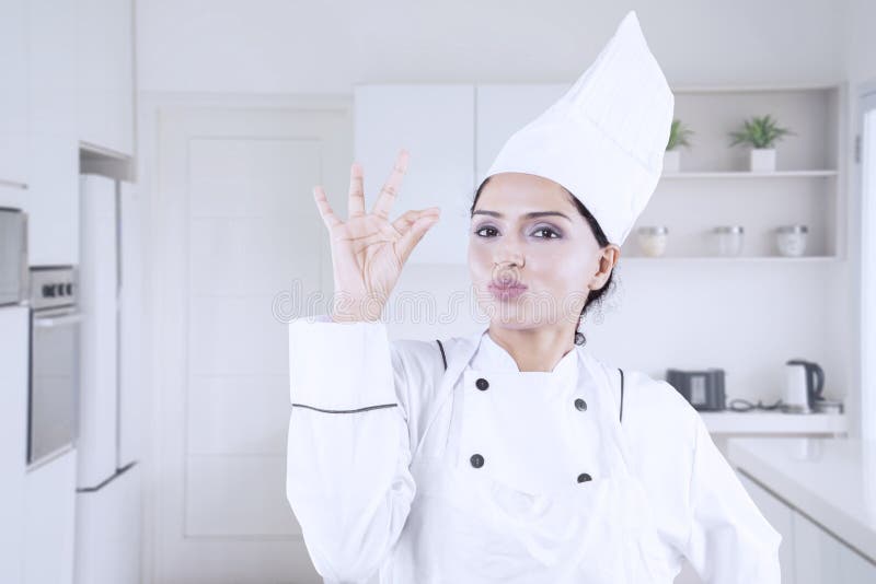 Young woman chef showing OK sign royalty free stock images Young woman chef showing OK sign royalty free stock images