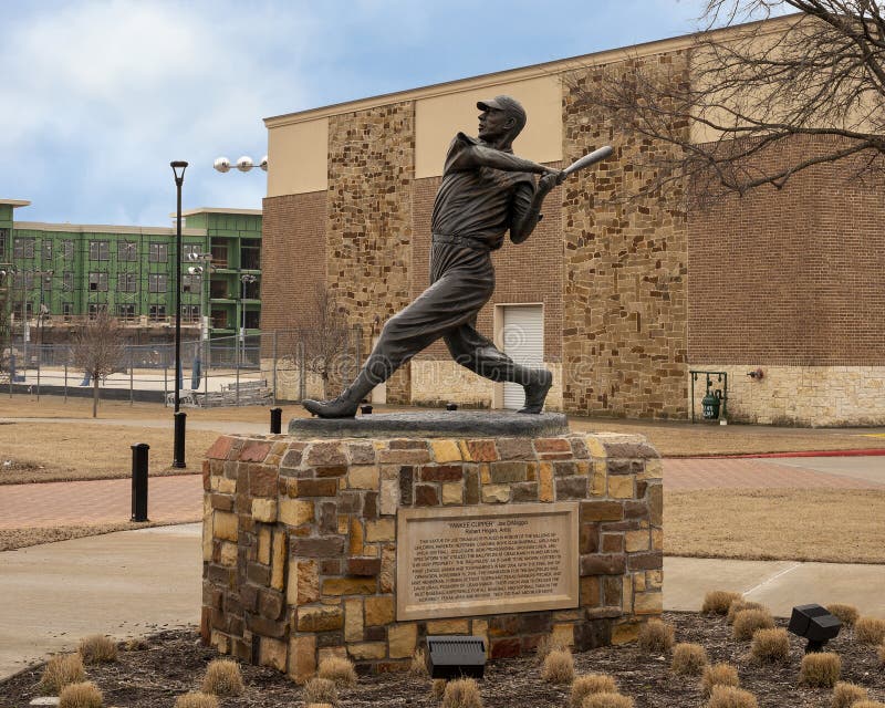 Pictured is a bronze sculpture of Joe DiMaggio titled `The Yankee Clipper` by Robert Hogan in McKinney, Texas.  The famous New York Yankees slugger is in motion at the plate, probably hitting another home run.  It was created in 2004 and is part of the public art collection of the City of McKinney.