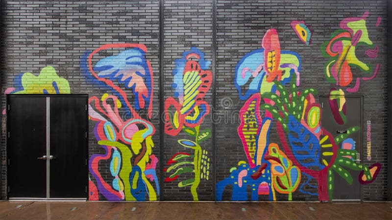 Colorful abstract mural by Mariell Guzman on the outside of a building in Dallas, Texas