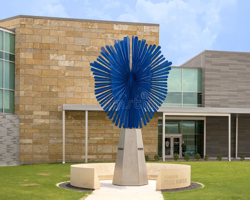 Pictured is a sculpture titled `Radiant Shield` by Shane Allbirtton and Norman Lee at the police station in the City of Richardson, Texas.  It is part of a police memorial, it`s surrounding low limestone wall being engraved on the inside with a quote, a poem, a reference to a fallen officer, and a dedication to the officers of the Richardson Police Department who have given their lives while serving and protecting the citizens.