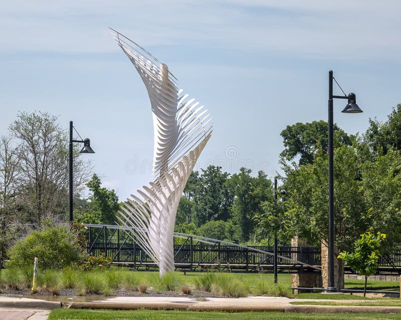 Pictured is `Seed Spire` by RE:site cofounders Shane Albritton and Norman Lee in Richard Greene Linear Park in Arlington, Texas. This dynamic sculpture features waterjet cut, organic steel forms that are connected to a central column in a spiraling configuration. It was completed in 2019. Pictured is `Seed Spire` by RE:site cofounders Shane Albritton and Norman Lee in Richard Greene Linear Park in Arlington, Texas. This dynamic sculpture features waterjet cut, organic steel forms that are connected to a central column in a spiraling configuration. It was completed in 2019.