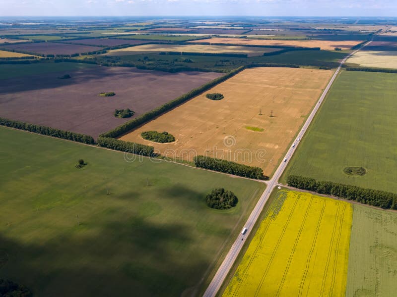 Picturesque aerial view of farmland on multicolored fields with crops sown and grown agriculture ripe for harvest wheat rye and stock image Picturesque aerial view of farmland on multicolored fields with crops sown and grown agriculture ripe for harvest wheat rye and stock image