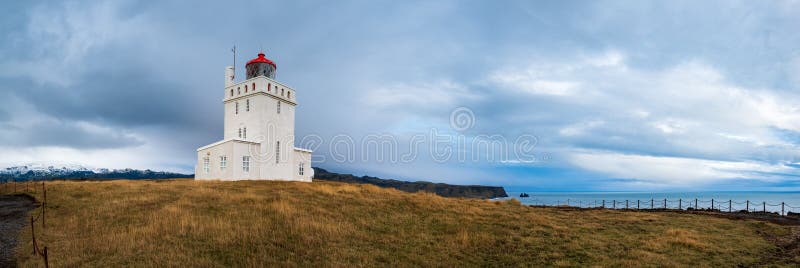 Picturesque autumn evening view to Dyrholaey lighthouse and Reynisfjara ocean black volcanic sand beach in far, Vik, South Iceland