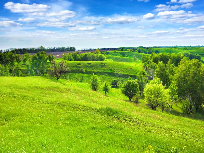 Picturesque hilly landscape with bright blue cloudy sky stock image Picturesque hilly landscape with bright blue cloudy sky stock image