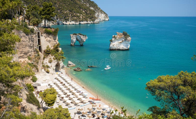 Picturesque Italian seascape with the Rocks of Faraglioni di Puglia in the Adriatic sea bay of Baia Delle Zagare - Mattinata, royalty free stock photos Picturesque Italian seascape with the Rocks of Faraglioni di Puglia in the Adriatic sea bay of Baia Delle Zagare - Mattinata, royalty free stock photos