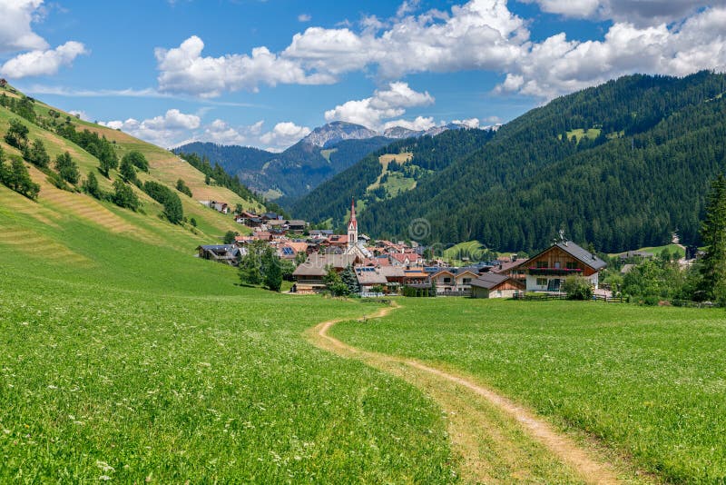 Picturesque path leading to a small beautiful alpine town Longiaru Campill stock photos Picturesque path leading to a small beautiful alpine town Longiaru Campill stock photos
