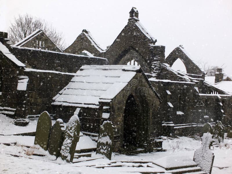 Picturesque ruined church in falling snow in heptonstall
