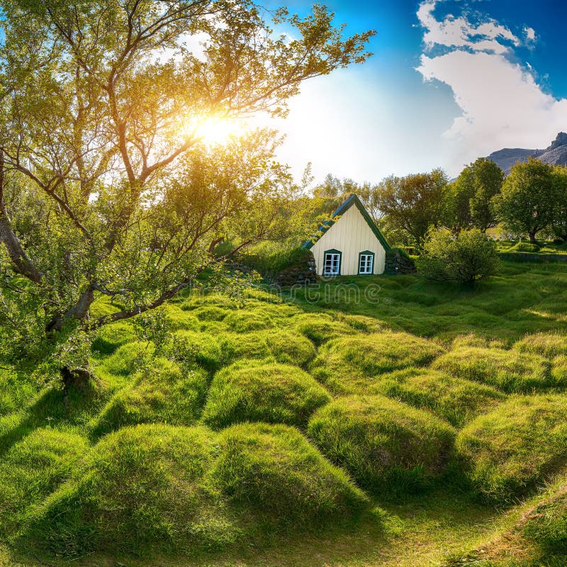 Picturesque view of  turf-top church Hofskirkja during sunset