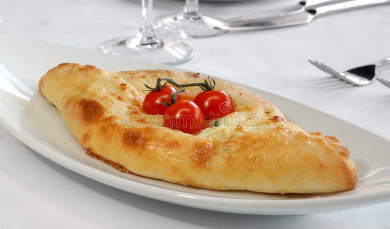 Pie with cheese and tomatoes on Georgian