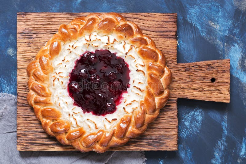 Pie with cottage cheese and berry jam close-up on a cutting board, top view. stock photography Pie with cottage cheese and berry jam close-up on a cutting board, top view. stock photography