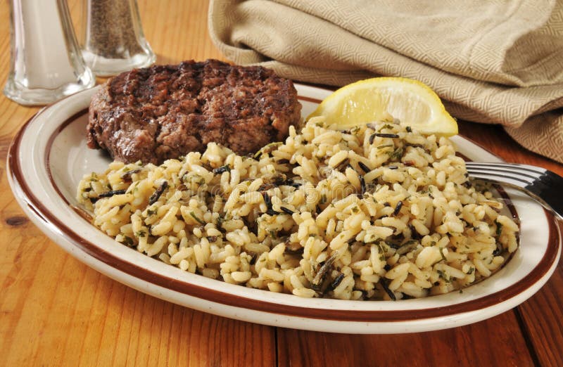 A grilled ground sirloin burger with long graina and wild rice. A grilled ground sirloin burger with long graina and wild rice