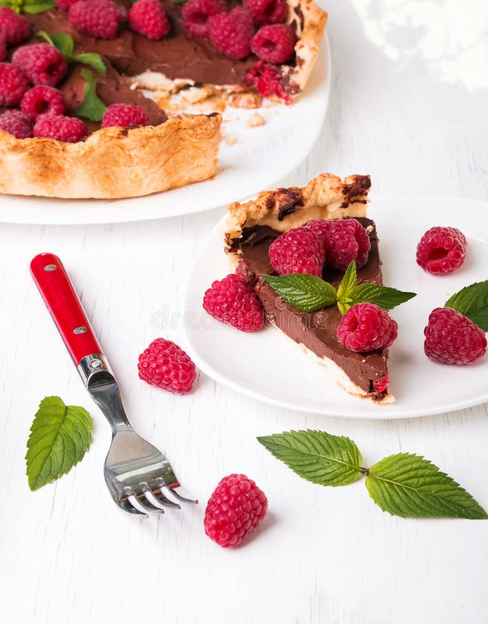 A piece of chocolate tart with raspberry